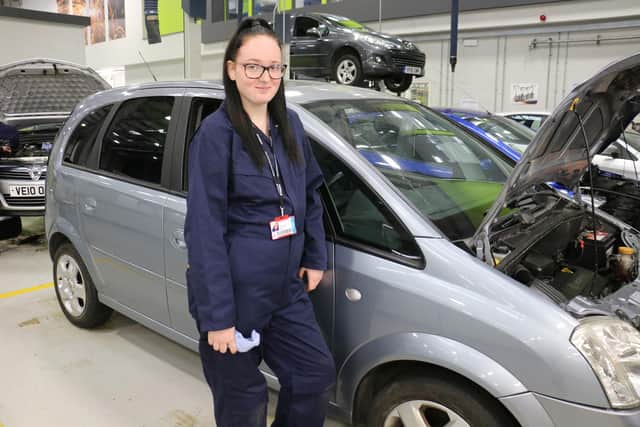 Sophie Colclough, an automotive maintenance beginners' diploma student, working on one of the donated vehicles.