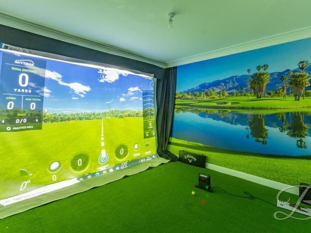 As well as the main hub of the house, there are two other reception rooms on the ground floor, overlooking the front of the property. Both are versatile, with this one currently being used as a golf simulator room.