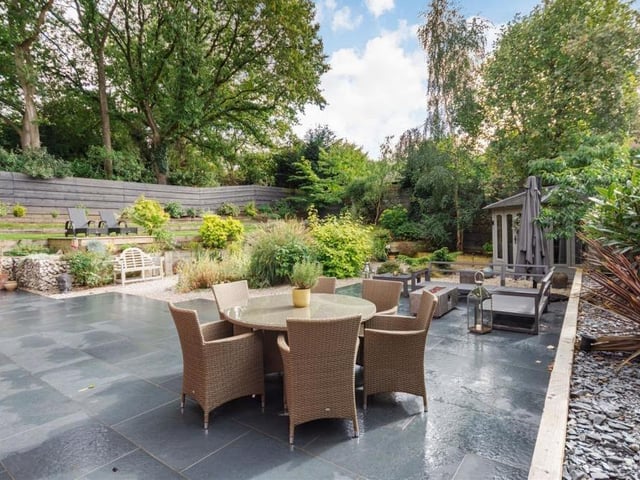 Let's take in a few exterior photos now, starting with this pleasant, blue sandstone patio, an important feature of the landscaped garden at the back of the £600,000 house.