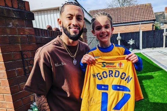 Former Stags player Kellan Gordon presents the signed shirt to fan Brendan Cliff at the seven-year-old's home in Clipstone.