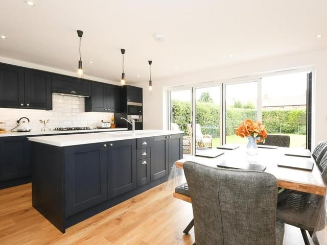 One of the most striking rooms on the ground floor is this modern, open-plan kitchen/diner. Integrated appliances include an electric oven, gas hob, fridge freezer, dishwasher and microwave. There are matching wall and base units, down spotlights, an island incorporating a sink, and also room or a dinner table. Double-glazed bi-fold doors lead to the garden.