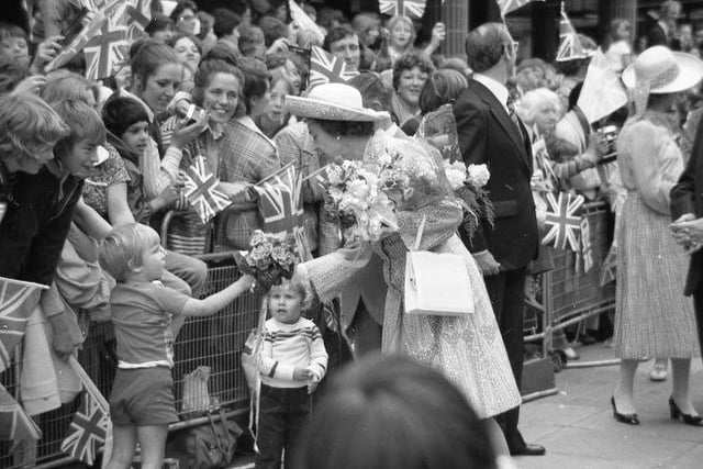Do you recognise these young fans presenting the Queen with flowers?