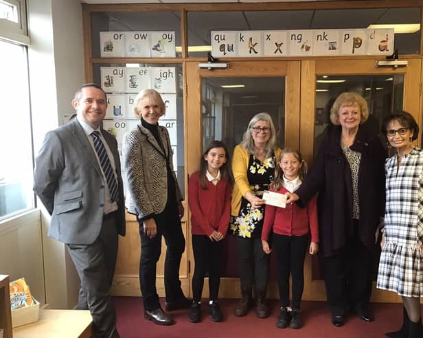 Head teacher James Marshall, trustee Jean Moulson, year four teacher Caroline Eady, trustee Vivienne Brown, chair of governors Christine Bacon and year four pupils Jess and Tianna.