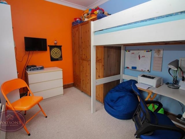 This bedroom on the first floor is so versatile that it could be put to multiple uses.