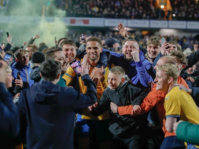 Mansfield Town's fans and players celebrated promotion to League One long into the night.