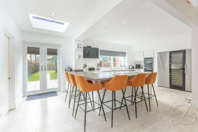 The sparkling kitchen offers space and style. Its focal point is a breakfast bar, where you can catch up with friends and family, while integrated appliances include a double oven, fridge/freezer and wine cooler. Injecting brightness are two skylights, a window to the back of the house and French doors leading outside.