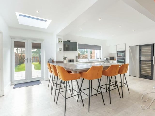 The sparkling kitchen offers space and style. Its focal point is a breakfast bar, where you can catch up with friends and family, while integrated appliances include a double oven, fridge/freezer and wine cooler. Injecting brightness are two skylights, a window to the back of the house and French doors leading outside.