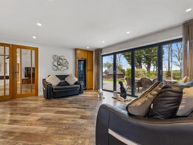 The light and bright family room has bifold doors providing access to a patio terrace, perfect for entertaining.