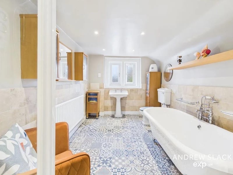 The family bathroom offers a freestanding bath and separate shower.
