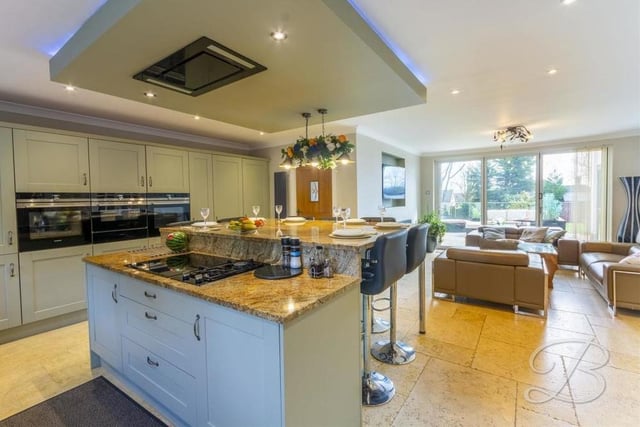 Let's start our photo tour of the Lichfield Lane house in the spacious, contemporary kitchen. It houses a range of excellent shaker-style units, along with magnificent integrated appliances. Its open-plan layout includes a lounge that you can see in the background.