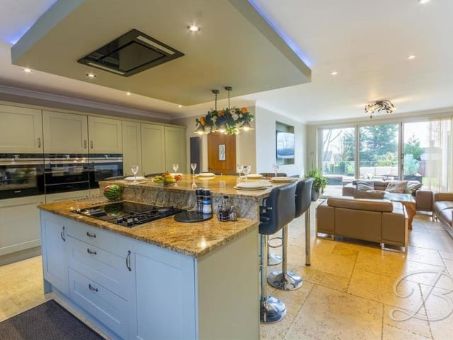 Let's start our photo tour of the Lichfield Lane house in the spacious, contemporary kitchen. It houses a range of excellent shaker-style units, along with magnificent integrated appliances. Its open-plan layout includes a lounge that you can see in the background.