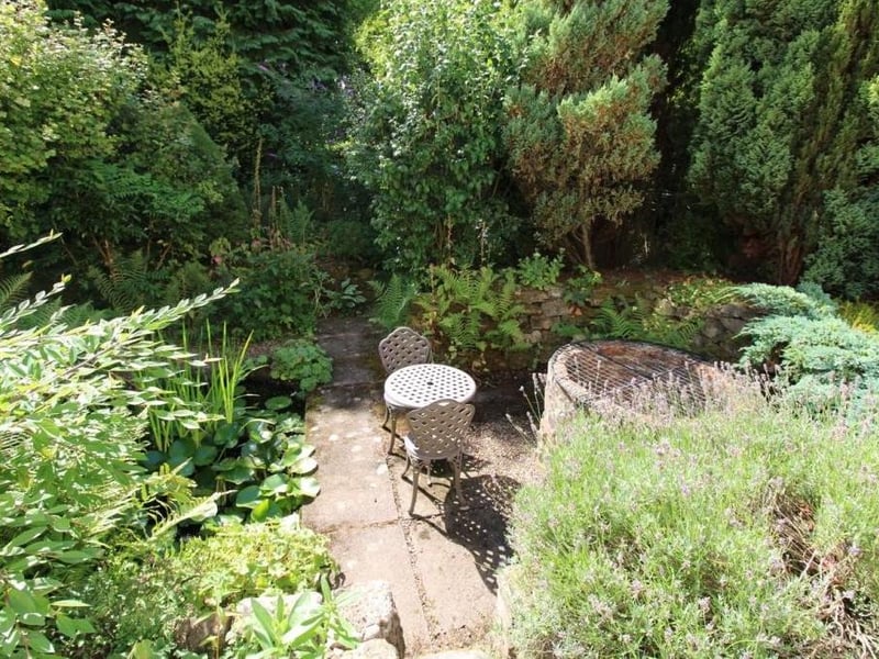 The garden, which stands in a plot of just over one-third of an acre, even features a covered well.