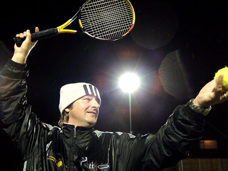 Tennis coach Dave Waring braved the rain to test out the new flood lit tennis courts at the Lawn Club.