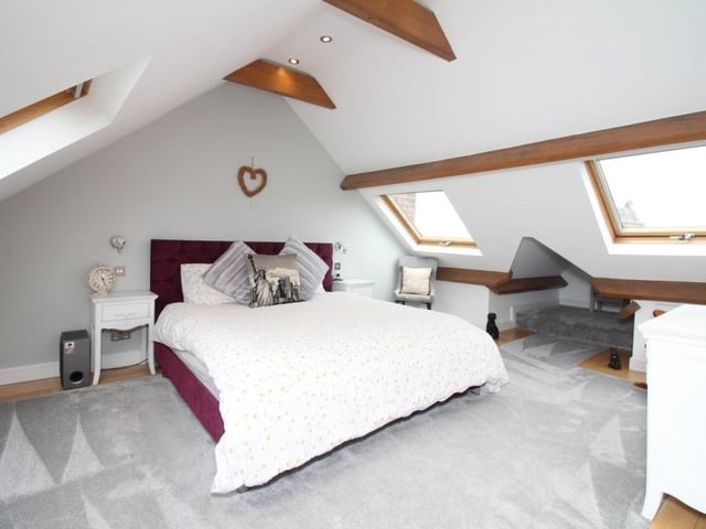 We launch our look at the five bedrooms by going up to the second floor to find the primary one, which mixes character with style and lots of space. It has four Velux windows, exposed beams, ceiling spotlights and eaves storage.