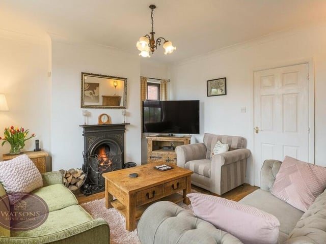 Let's open our gallery in the lovely lounge, which is one of two reception rooms on the ground floor of the £475,000 Bagthorpe property. At its heart is a cast-iron feature fireplace, while other assets include a wood-effect laminate floor and double-glazed windows to the front and side of the house.