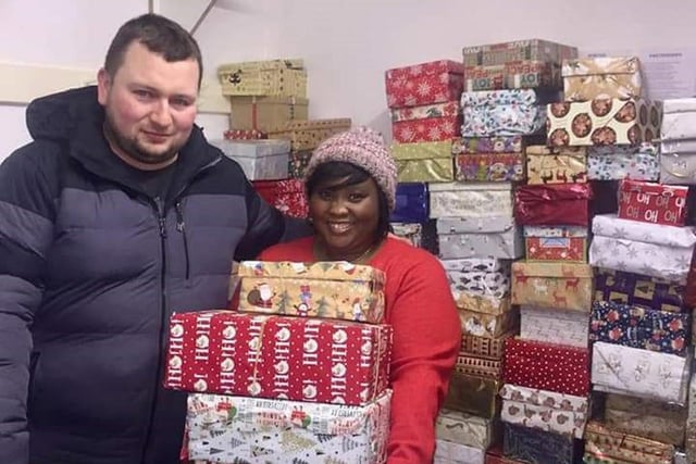 Mydudu Nadzieja and her husband Wojciech with gifts from Chesterfield Shoebox Appeal which were handed out to guests at Christmas Lunch On Jesus in 2018