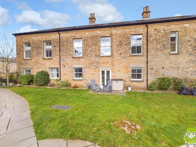 At the back of the house is a patio and seating area, accessed via the double doors in the open-plan kitchen/lounge/diner.