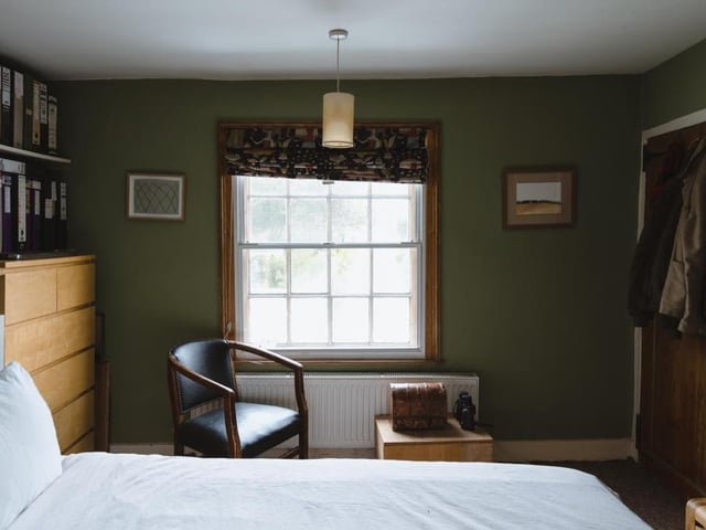 All three of the double bedrooms on the first floor of the main house have large sash windows. This photo also shows a large wardrobe in the master bedroom.