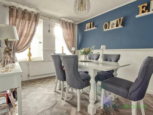 Moving on now to the second reception room, a delectably presented formal dining room, which boasts a vinyl floor and two windows facing the front of the house.