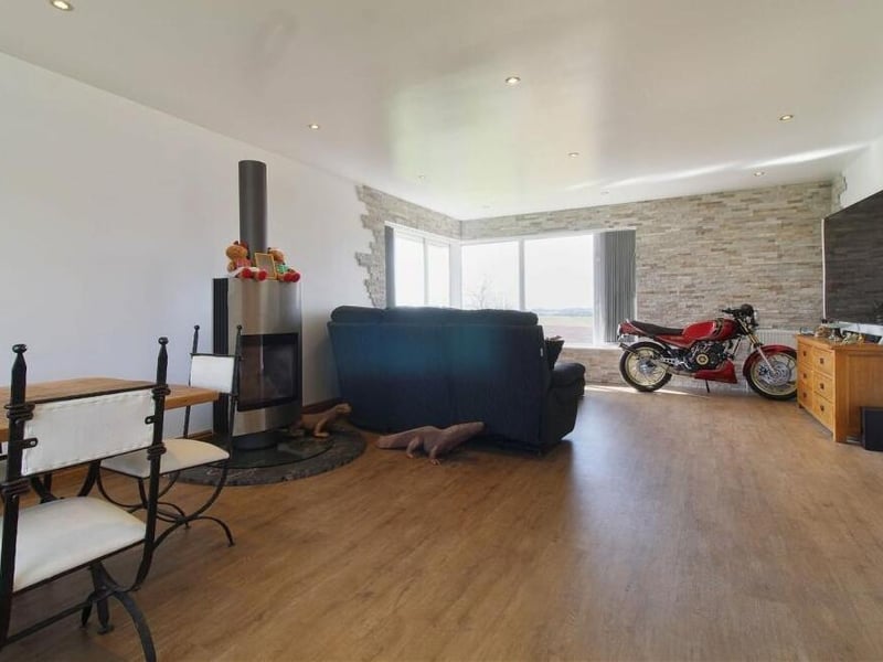 How do you fancy unlocking the potential of this spacious lounge, which comes complete with a feature fireplace?