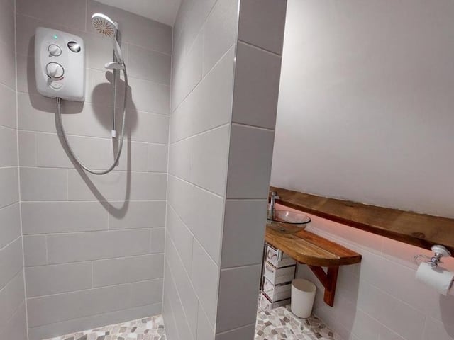 The master bedroom boasts its own en suite. It is newly installed, complete with this stylish shower cubicle.