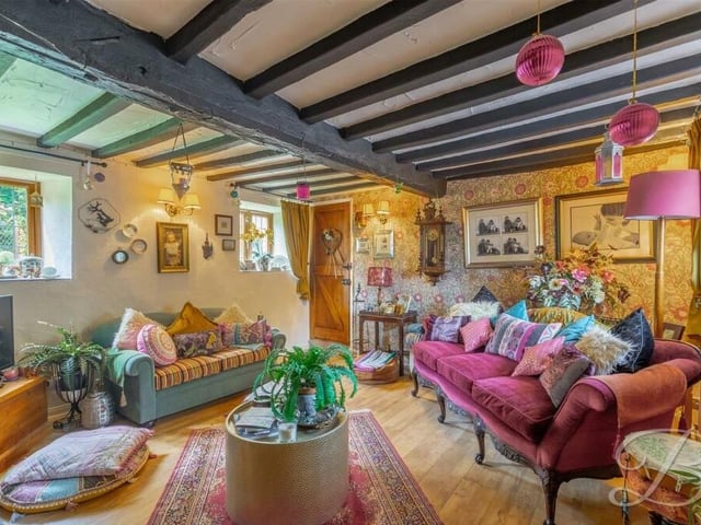 Moving on from the breakfast kitchen, we come to the beautiful and comfortable living room, which features exposed ceiling beams and windows to the side of the Church Road property.
