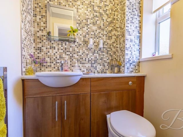 The ground floor has its own toilet, complete with low-flush WC, vanity hand wash unit, lovely mosaic tiling and chrome, heated towel-rail.