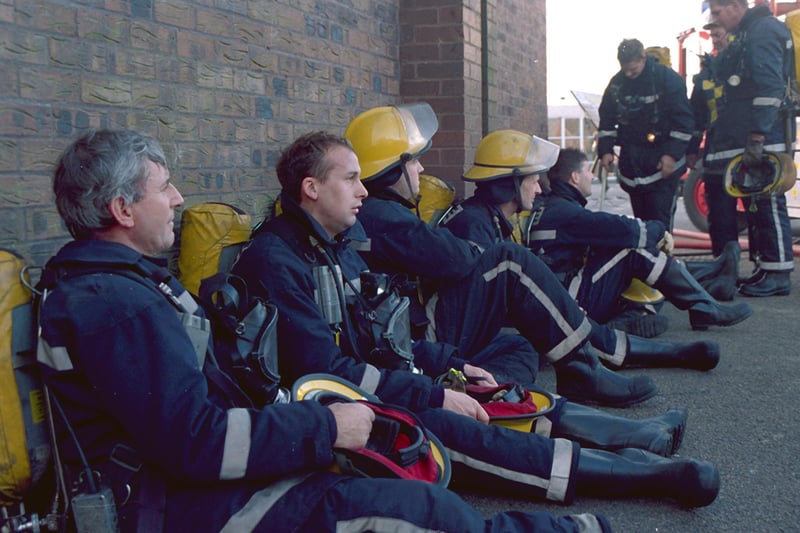 Exhausted firefighters pictured outside Joseph Whitaker school following a fire in 1980.