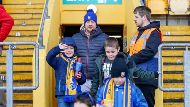 Mansfield Town fans watch the match against Northampton.