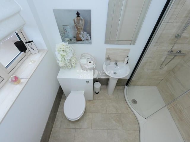 The first floor hosts this second en suite shower room, which is accessed from the fourth bedroom. It consists of a walk-in shower cubicle, wash hand basin, WC and partly-tiled walls.