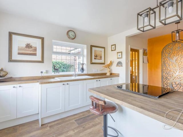 The classy kitchen from a different angle. It is bright and airy, and there is plenty of space to show off your culinary skills.
