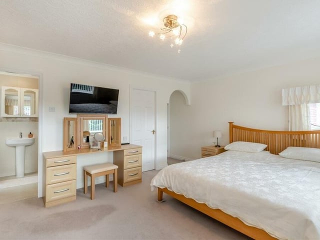 The master bedroom features a fitted dressing table with six drawers. As you can see, there is access too to en suite facilities.