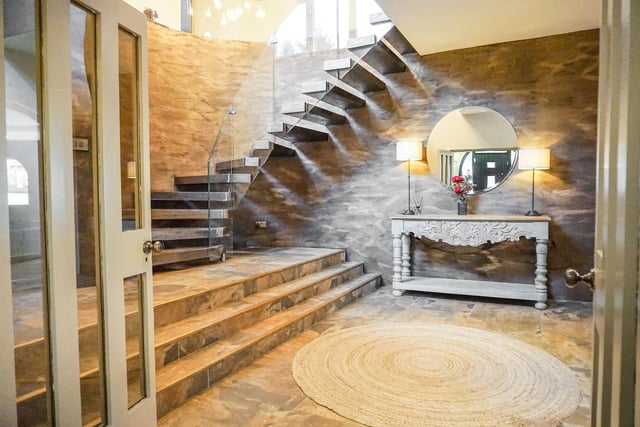 The semi circular staircase - in Venetian plaster with a metallic finish and glass balustrade - delivers the wow factor.