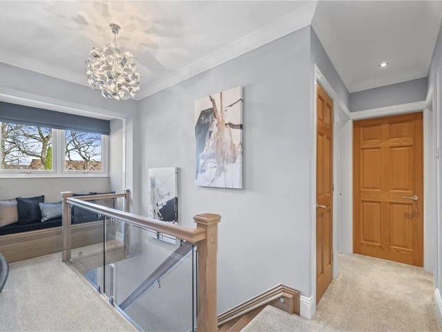 Oak and glass balustrade with feature window seat, double glazed window to front aspect with doors leading to all bedrooms and family bathroom, airing cupboard and carpeted flooring.
