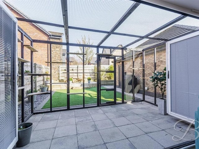 Bi-folding doors open up to the rear garden, allowing natural light to flood the room and bringing the outdoors in.