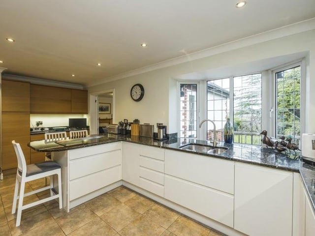 Another shot of the kitchen, which has to be considered a chef's dream. It is fitted with matching wall and base units, with granite worktops incorporating an inset one-and-a-half stainless steel sink and drainer with mixer tap. A huge double-glazed bay window guarantees plenty of natural light.