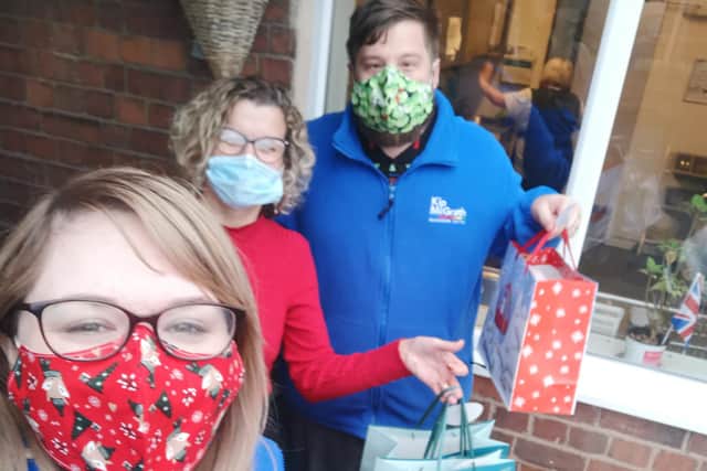 Tasha and James Cotterill handing over donated gifts to care home manager Sheena Pearce