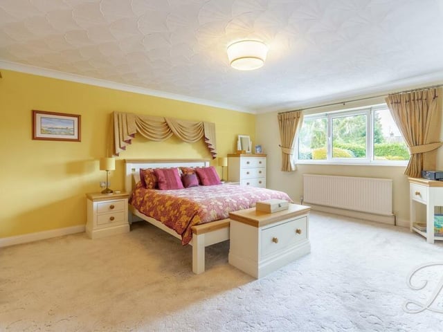 The first of the four bedrooms we visit is this master, with its fitted carpets, fitted wardrobes, en suite access and window overlooking the back of the house.
