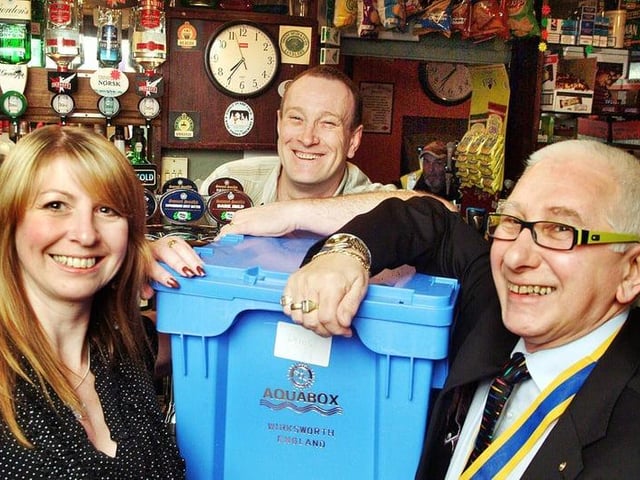 Steve and Nikki Smith, of the Rose and Crown in Sutton, hand over an aquabox to Kirkby Rotary Club president Bill Wilson in 2008.
