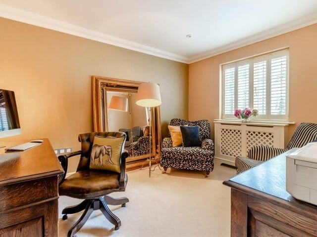 The ground floor also houses a handy home office, with ceiling spotlights and coving to the ceiling. Note the window shutters and radiator covers, which can be found throughout the house.