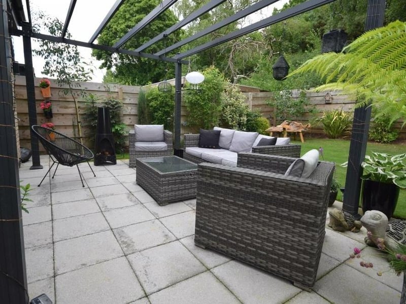 The last photo of our gallery shows how the patio and pergola fit neatly within the back garden, offering the ideal opportunity for barbecues and al fresco dining.