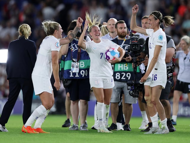 Beth Mead picks up the match ball after her hat-trick