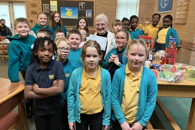 Joan Cannan, co-founder, secretary and treasurer of Forget-Me-Not Dementia Support Group, is pictured with youngsters from Kingsway Primary School.
