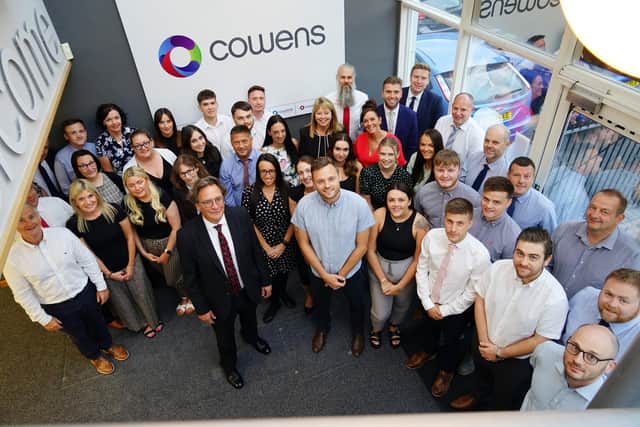 Coun Ben Bradley, centre, with staff at Cowens.