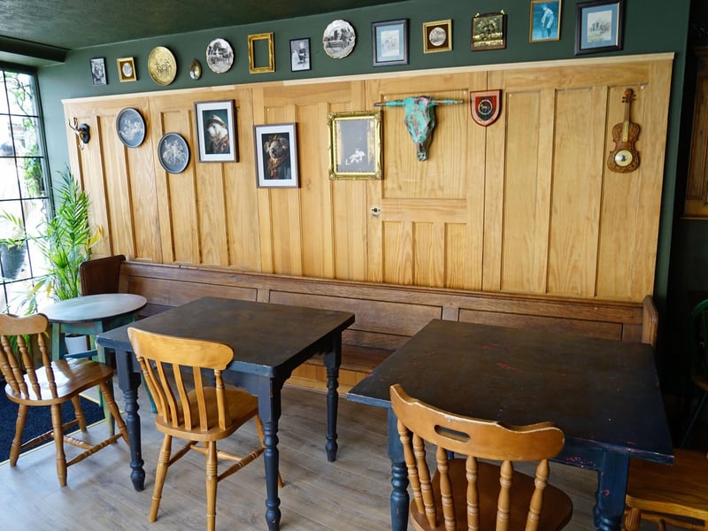 Old doors create distinctive wall panelling on the ground floor. The pew originally came from a church which burned down.