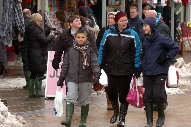 Christmas shoppers brave the inclement weatherand dodge the snow piles in Barnsley town centre in 2010