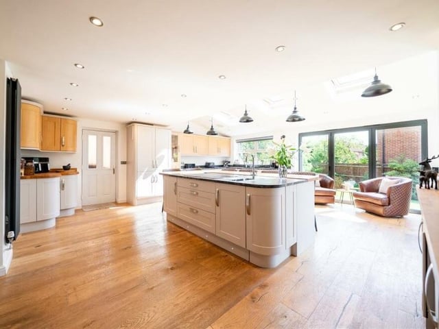 The kitchen features an array of high-spec, integrated appliances and granite and solid-oak worktops. Those appliances include a hide-and-slide oven, a microwave, an induction hob and a plate-warmer, all by Neff.