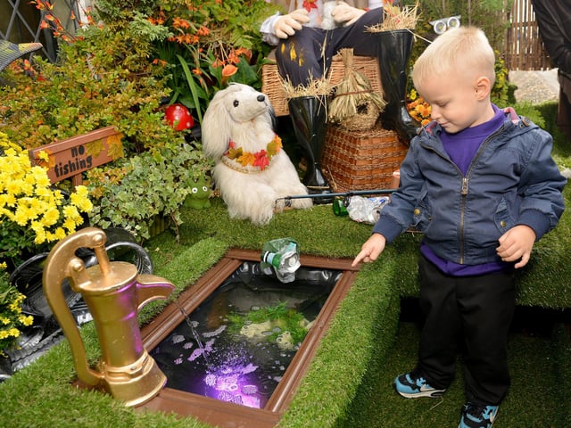 Judging of the Huthwaite Scarecrow competition in 2018, Mason Lakin, three checks out one of the displays