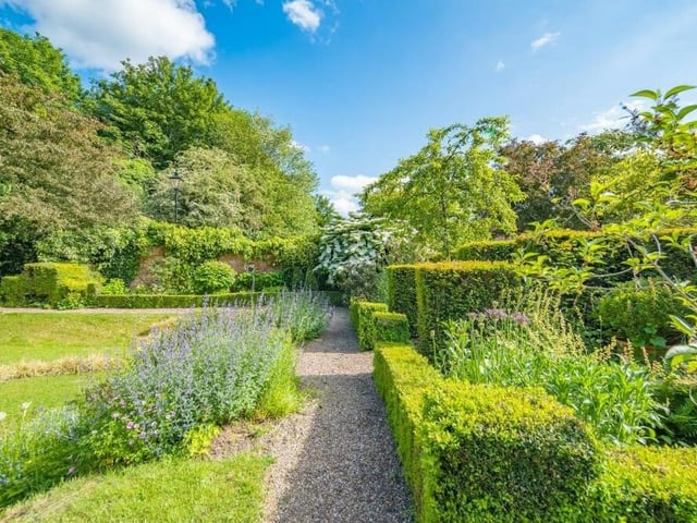 The well manicured garden features pathways to take you on relaxing walks.