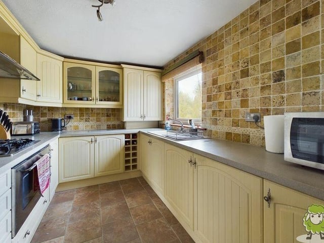 Let's have a look now at the property's annexe, which offers additional living accommodation on the lower ground floor. This is the fully equipped kitchen with a range of units and appliances.